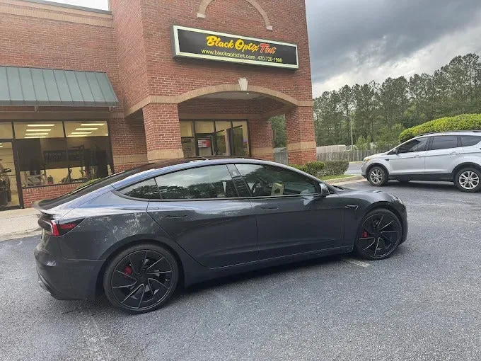 Tesla Model 3 tinted outside the Fayetteville storefront