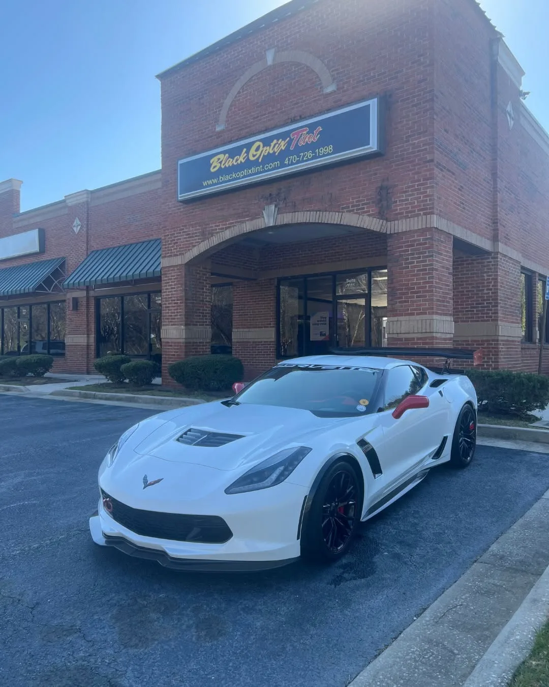 White Corvette Z06 with fresh ceramic tint outside Black Optix Tint Atlanta